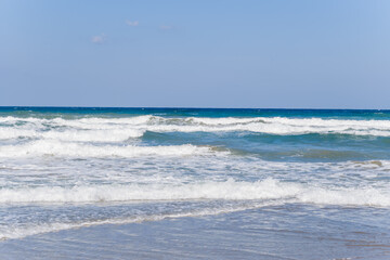 Georgioupolis Sand Beach at the foot of the mountains , in Europe, Greece, Crete, towards Rethymno, By the Mediterranean Sea, in summer, on a sunny day.