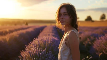 Rolgordijnen A beautiful young woman in a dress around happily in a field of lavender, France. © ND STOCK