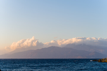 The arid rocky coast and its green countryside, in Europe, Greece, Crete, towards Matala, By the Mediterranean Sea, in summer, on a sunny day.