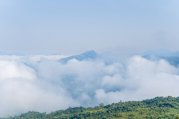 The clouds above the city seen at the green mountains , in Asia, Vietnam, Tonkin, Dien Bien Phu, in summer, on a sunny day.