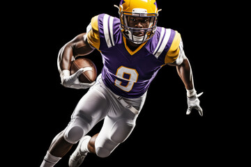 Portrait of American football player running with the ball. Muscular athlete in a purple and yellow uniform with an ovoid ball in a dynamic pose. Isolated on black background.