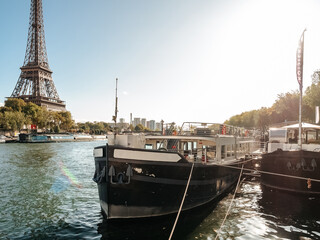 Tourist ships on the Seine embankment with a view of the Eiffel Tower