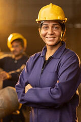 Woman welder in metalworking workshop 