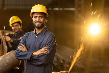 Industrial worker at factory, looking at camera. - obrazy, fototapety, plakaty