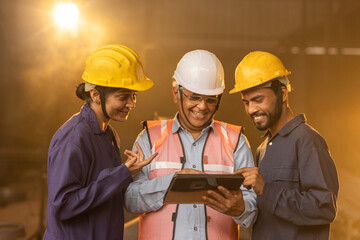 Mechanic and female engineer using digital tablet at factory. - Powered by Adobe
