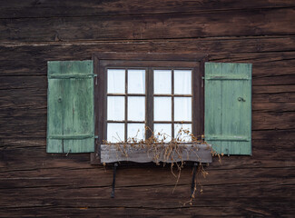 window with shutters of old farmhouse.