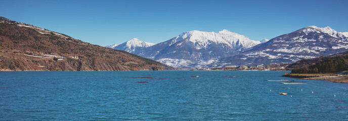 View of Serre-Poncon mountain lake in winter from the Savines Bridge. Hautes Alpes, France