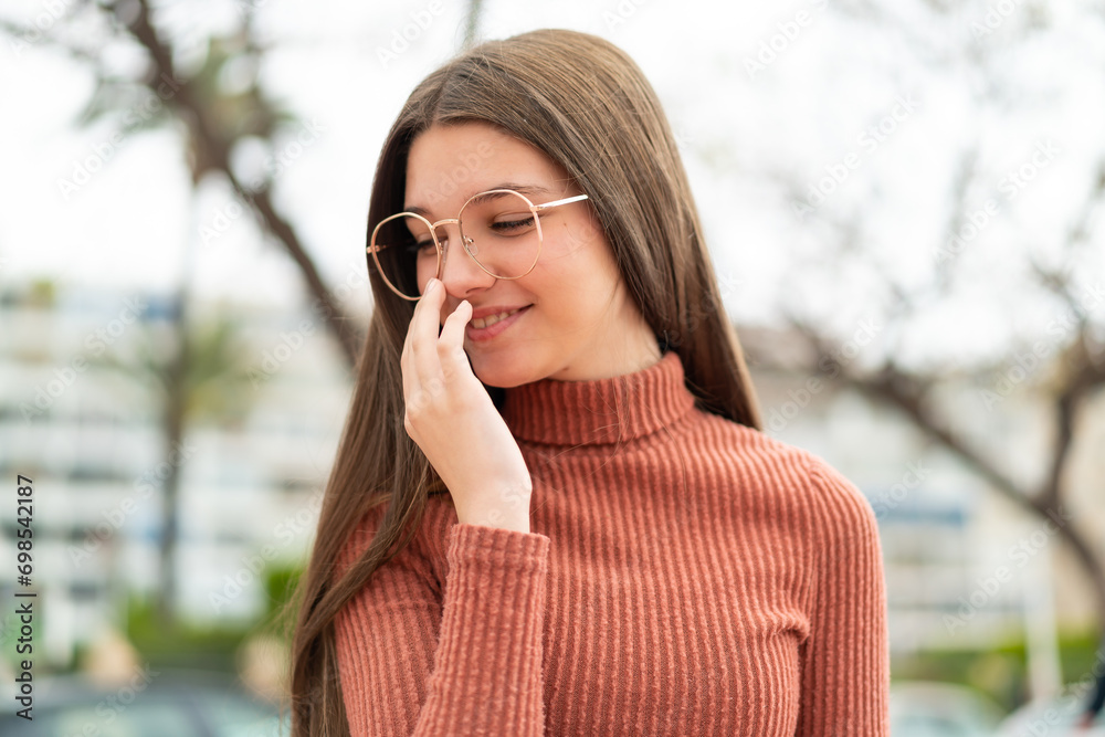 Poster Teenager girl at outdoors smiling a lot