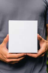 Holding white small box mockup in hand