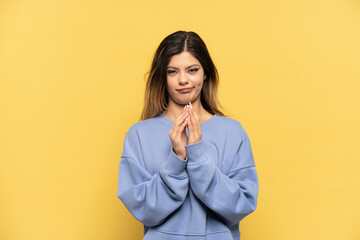 Young Russian girl isolated on yellow background scheming something