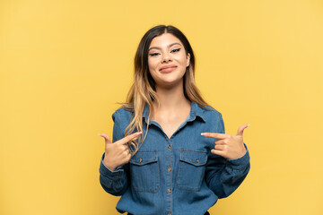 Young Russian girl isolated on yellow background with surprise facial expression