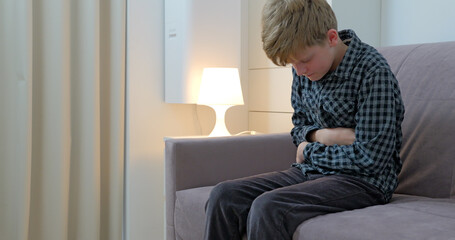 Little boy suffering from stomachache at home.The child has a stomach ache.