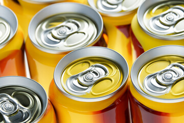 soda production. many yellow aluminum cans with drinks, close-up. drinks concept
