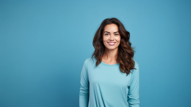 Smiling attractive woman look to the camera on blue background