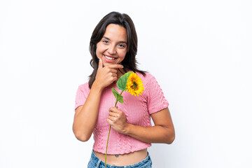 Young hispanic woman holding sunflower isolated on white background happy and smiling