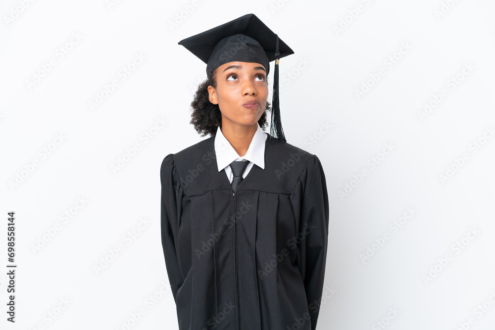 Sticker Young university graduate African American woman isolated on white background and looking up