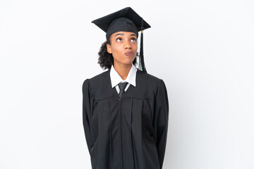 Young university graduate African American woman isolated on white background and looking up