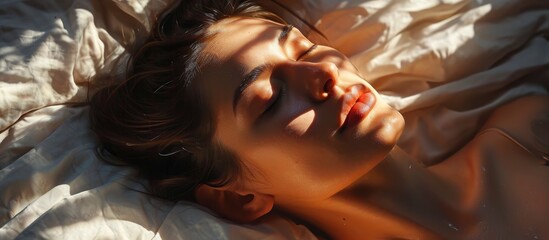 Serenely sleeping woman with sunbeam on her face. - obrazy, fototapety, plakaty