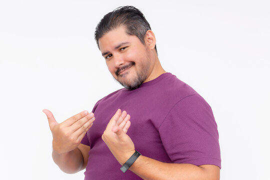 A cocky man points to himself bragging while looking smug. Wearing a purple waffle shirt. Half body photo isolated on white background.