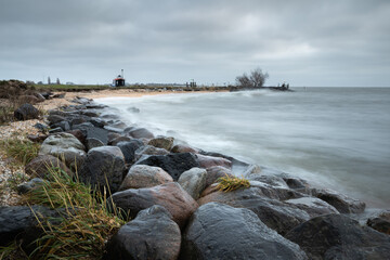 Stormy morning at the Markermeer (Netherlands). Clouds, wind, and high waves this morning. The rocks are being washed clean by the waves.