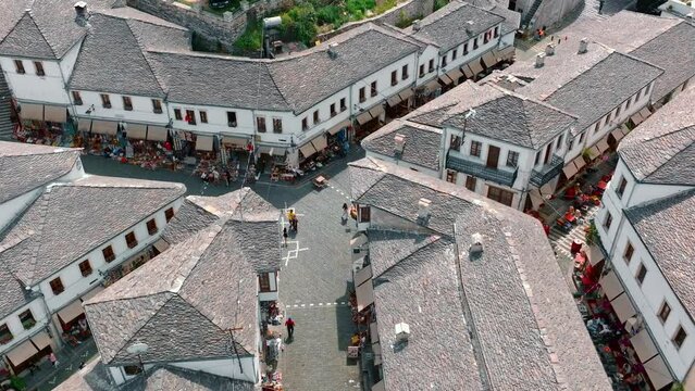Aerial drone view of old quarters of Gjirokaster, Albania. Traditional houses in the old city of Gjirokaster. UNESCO World Heritage Site.
