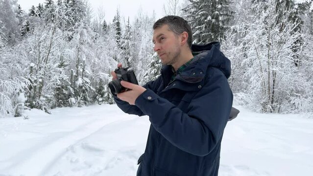 A man takes pictures of a winter landscape