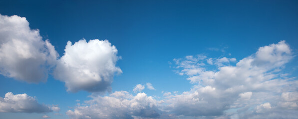 blue sky background with big cumulus clouds below