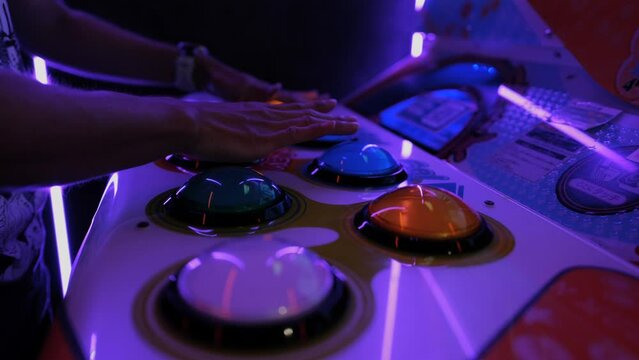 Close up of a person hands playing an arcade video game in Akihabara in Tokyo