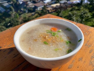 Rice porridge serving in white bowl for breakfast and soft diet concept 