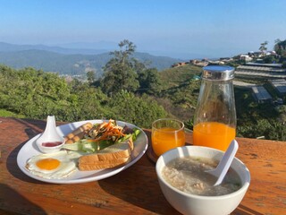 Set of breakfast which is bread salad fried egg orange juice and rice porridge for breakfast concept 