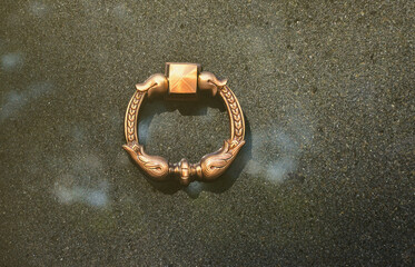 Metal ring on grave of cemetery. Rusty iron handle on granite tomb cover. An 19th century antique...
