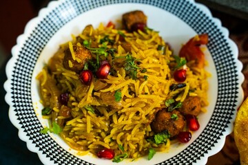 khichdi or khichri, Homemade delicious traditional spicy Indian dish consisting of rice, pomegranate seeds, Soya Chunks, tomatoes and spices. Flavorful Chana Pulao with Basmati Rice, Soya Chunks.