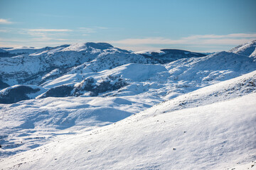 Fototapeta na wymiar Pristine snow blankets rugged terrain.