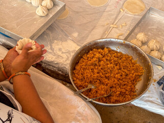 Preparing sweet dumplings called modak for Ganesh Chaturthi festival in India. Dumplings made of coconut and jaggery