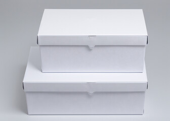 Two white boxes with bows. 