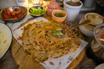 Vadapav paratha is a popular North Indian flatbread made with whole wheat flour dough and stuffed with potato, gram flour, garlic chutney and spices. Homemade wheat stuffed spicy paratha. 