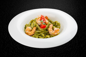 Fettuccini with shrimp and pesto sauce. Isolated image