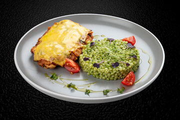 Chicken schnitzel under cheese with pittitimus. Isolated image