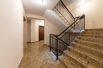 Modern stair case between floors. Stairs with metallic rail  in modern building