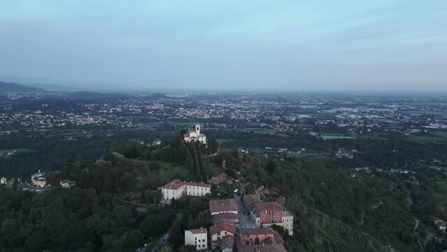Aerial shot of the little village of Montevecchia, Italy. Stunning architecture and beautiful forests around. Countryside in the background. 4K drone shot.