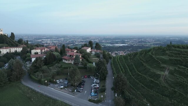 Aerial orbit of italian countryside at sunset from the little village of Montevecchia, Italy. Stunning architecture and beautiful forests around. 4K drone shot.