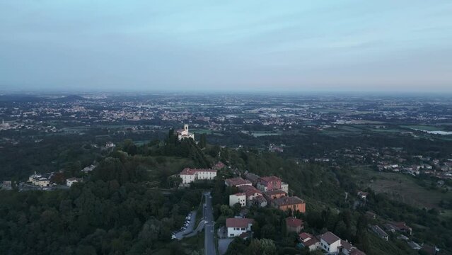 Aerial shot of the little village of Montevecchia, Italy. Stunning architecture and beautiful forests around. Countryside in the background. 4K drone shot.