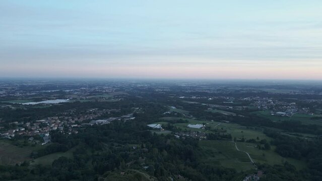 Aerial view of italian countryside at sunset from the little village of Montevecchia, Italy. Stunning architecture and beautiful forests around. 4K drone shot.