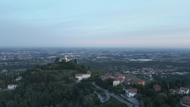 Aerial shot of the little village of Montevecchia, Italy. Stunning architecture and beautiful forests around. Countryside in the background. 4K drone shot.
