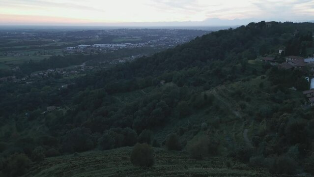 Aerial view of italian countryside at sunset from the little village of Montevecchia, Italy. Stunning architecture and beautiful forests around. 4K drone shot.