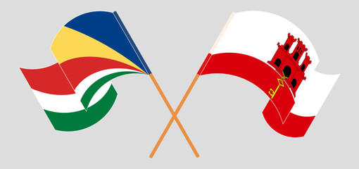 Crossed and waving flags of Seychelles and Gibraltar