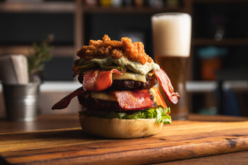 Spectacular double burger with cheese, bacon, fried onion rings, aioli sauce, bacon and lettuce,...