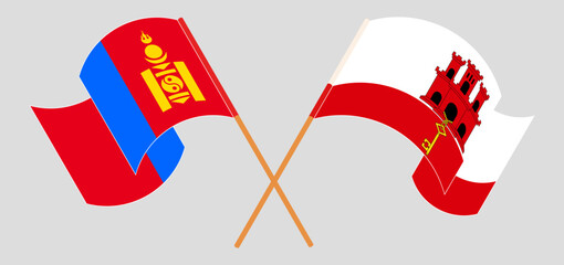 Crossed and waving flags of Mongolia and Gibraltar
