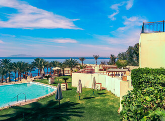 empty lawn with folded umbrellas on the coast of southern Sinai Egypt Sharm El Sheikh