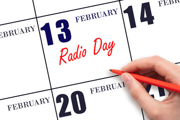 February 13. Hand writing text Radio Day on calendar date. Save the date.